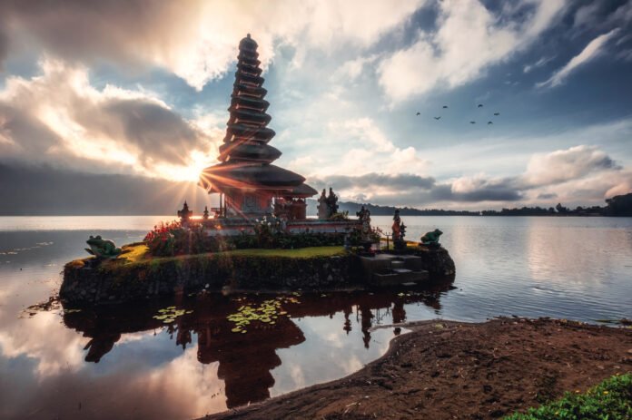 Sunrise shining on ancient temple of Pura Ulun Danu Bratan on Br